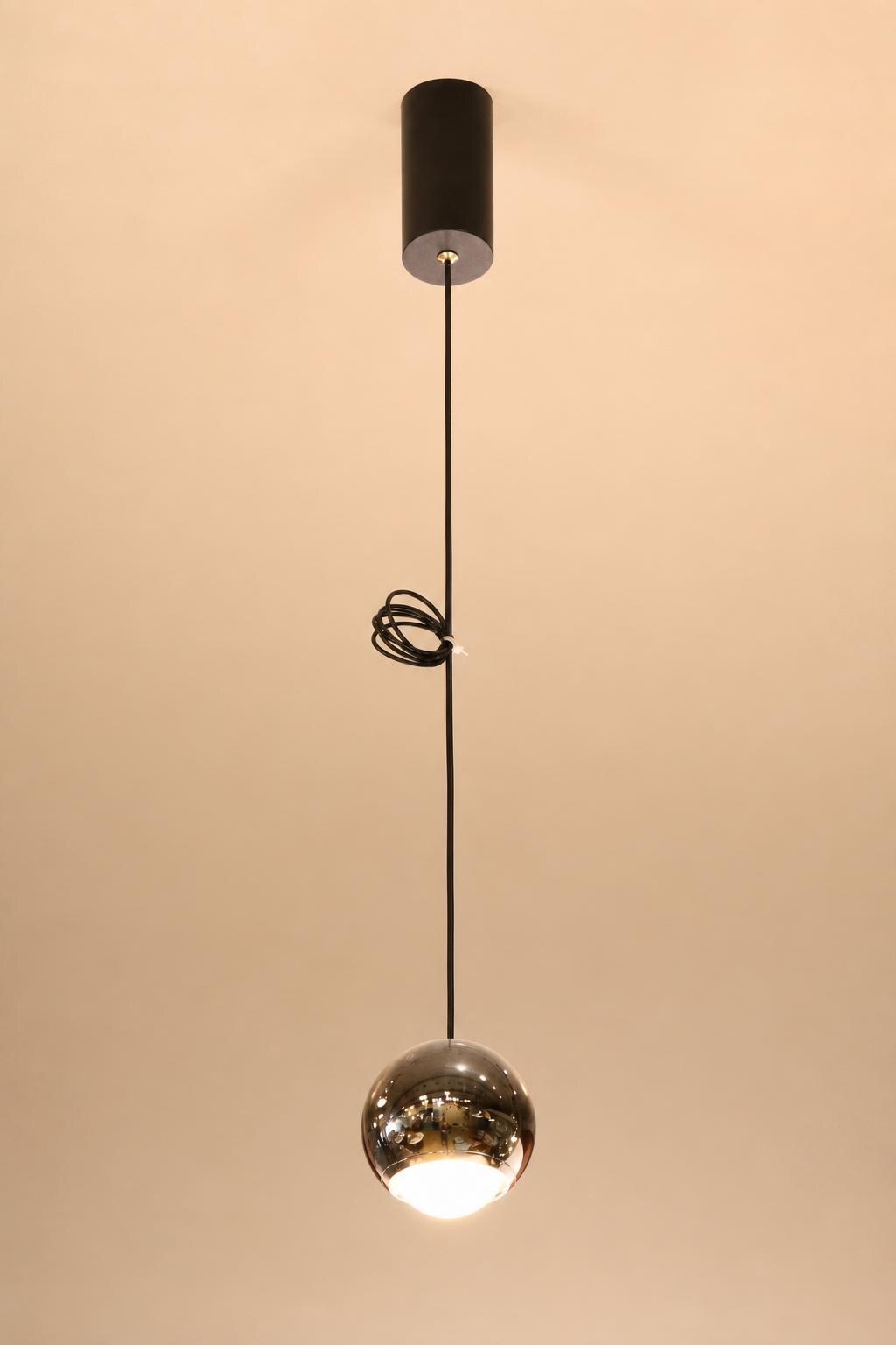 Single Chrome Globe Pendant Light with Black Cord - Studio presentation